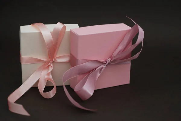 Two Gift Boxes with a pink bow Isolated on Brown Background. Gift, birthday. Sale Concept. Copy space for Text. — Stock Photo, Image