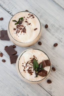 Buzlu Mocha kahve kırbaç krem, yaz kez içme. Kahve çekirdekleri. rustik ahşap arka plan dokulu. Nane yaprakları