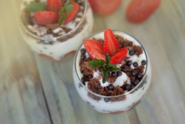 Cam beyaz Crea ile Çilekli pasta çilekli mans. Ev yapımı yaz tatlı beyaz rustik masada.