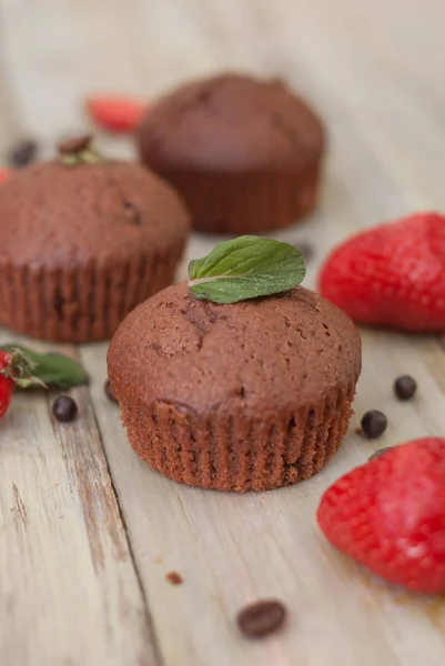 Chocolate Muffins with Strawberry Mint Leaves over rustic Gray Background Breakfast desert — Stock Photo, Image