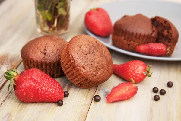 Chocolate Muffins with Strawberry Mint Leaves over rustic Gray Background — Stock Photo, Image