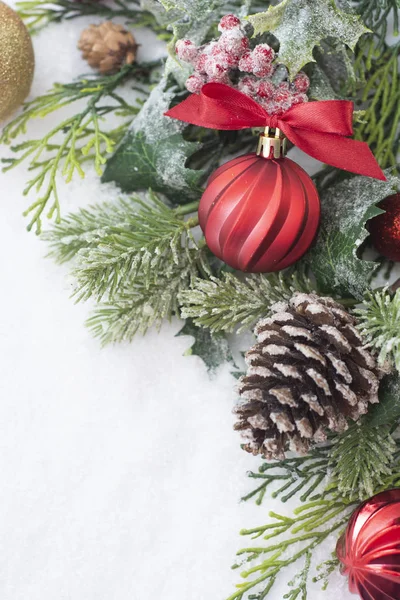 Fondo de Navidad con bolas, adornos y ramas de abeto verde, conos de pino, sobre fondo de nieve blanca. Vacaciones de invierno. Tarjeta de felicitación abstracta de Navidad. Copiar espacio . — Foto de Stock