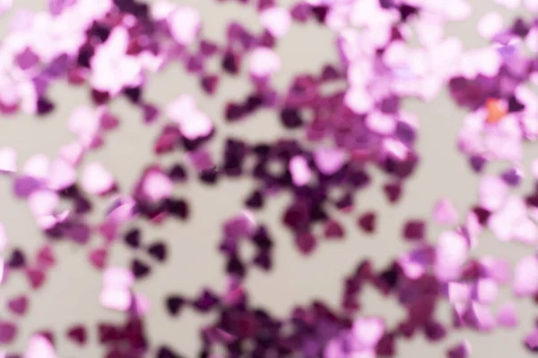 Pink glitter background unfocused. Abstract heart shaped purple sparkling glitter. Christmas, holidays.