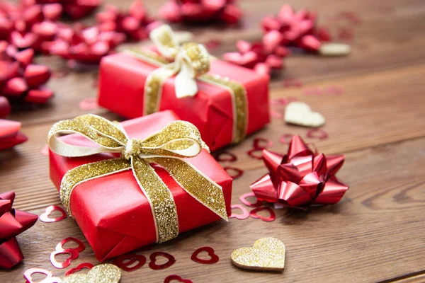 Red gift box with bows, on wooden background. Copy space. Valentine's day, birthday, Christmas. — Stock Photo, Image