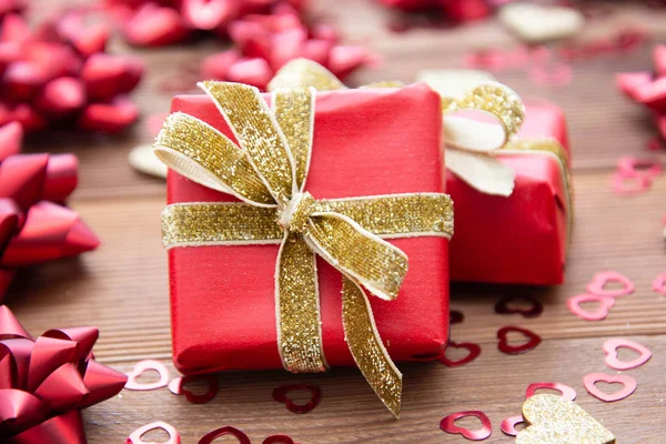 Red gift box with bows, on wooden background. Copy space. Valentine's day, birthday, Christmas. — Stock Photo, Image