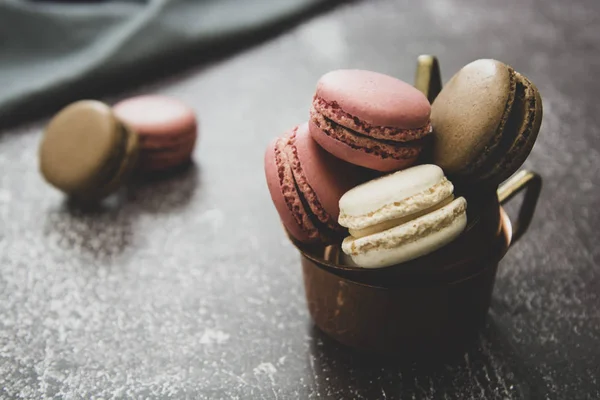 Macarons isolated on dark background. Healthy cake dessert made from almond flour. Vintage dark toned image. — Stock Photo, Image