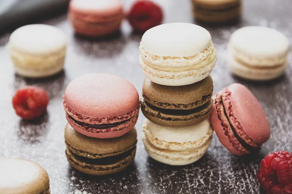 Heap of macarons isolated on dark background. Healthy cake dessert made from almond flour. Raspberry macaroons cookies. — Stock Photo, Image