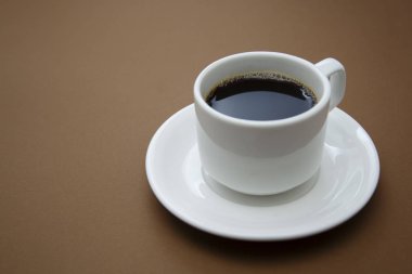 Kahve fincanı kahverengi masada izole edilmiş. Fotokopi alanı olan kahve..