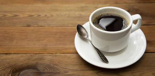 Coffee cup isolated on wooden table. Top view, flat lay coffee drink with copy space.