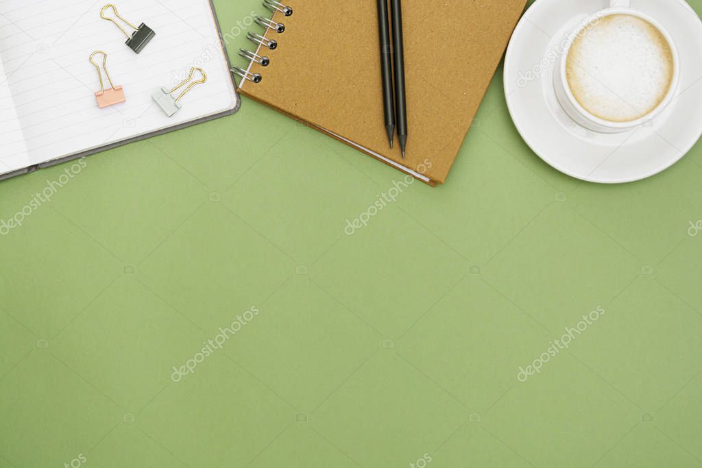 Office table with notebook and coffee cup. Top tabpe, work space with copy space. Creative flat lay.