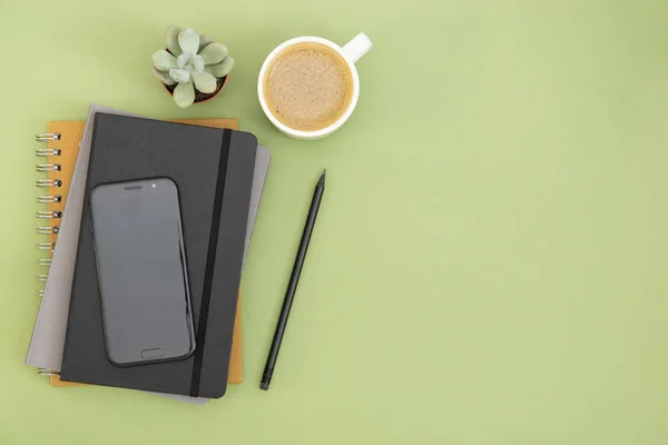 Vista superior da mesa de trabalho. notebook preto fechado, xícara de café e smartphone. Copiar espaço para texto. Design mock up . — Fotografia de Stock