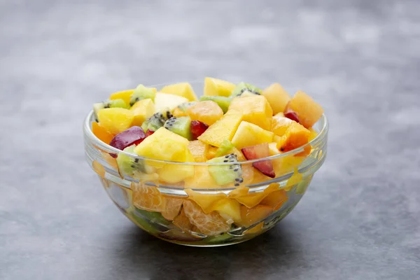 Fresh fruits salad - mango, citrus, kiwi fruit, plum and persimmon. Healthy food. Smoothie mix.