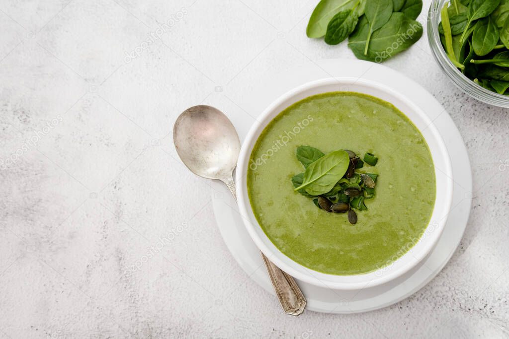 Creamy vegetable soup on bright table. Healthy detox food. Vegetarian food.