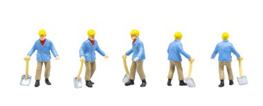 Miniature figurine character as railway track worker posing in posture isolated on white background.