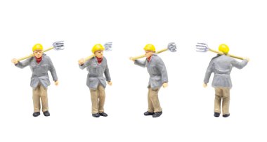 Miniature figurine character as railway track worker posing in posture isolated on white background.