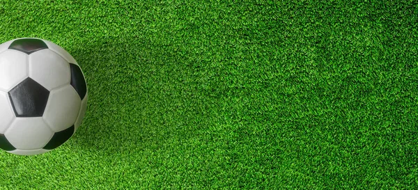 Top view of Soccer ball or Football on green artificial grass.