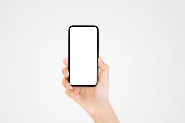 ビジネスコミュニケーションコンセプト 灰色の背景を持つ古い黒のスマートフォンを手で握る — ストック写真