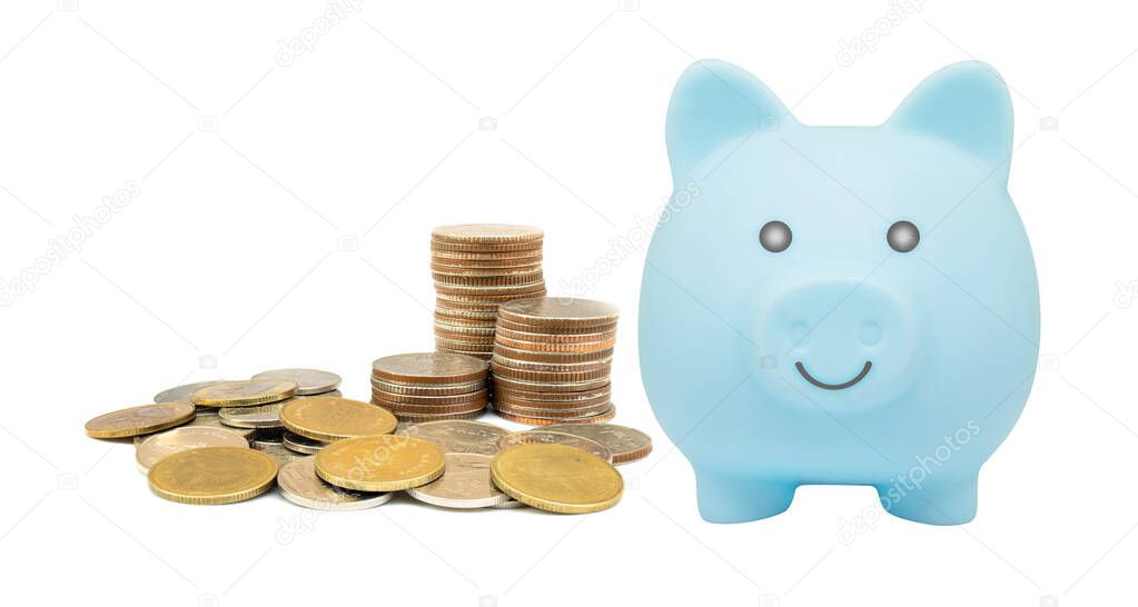 Money Savings Concept : Stacked silver coins and blue piggy bank isolated on white background.