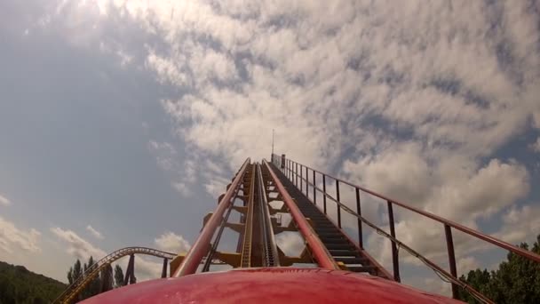 First climb up roller coaster in theme park — Stock Video