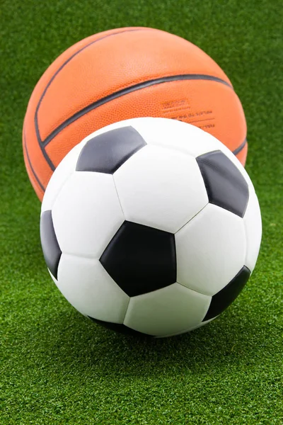 soccer ball with basketball on green grass background