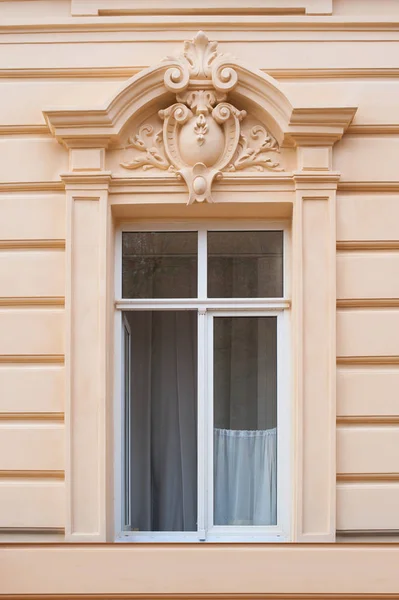 Old architectural window decorated with stylized ornament — Stock Photo, Image