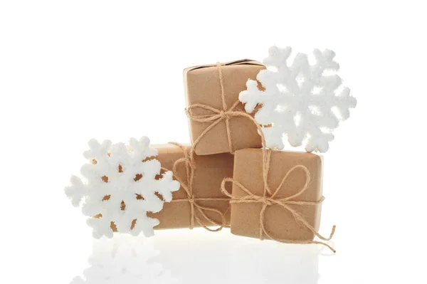Holiday boxes and toy snowflakes on white background — Stock Photo, Image