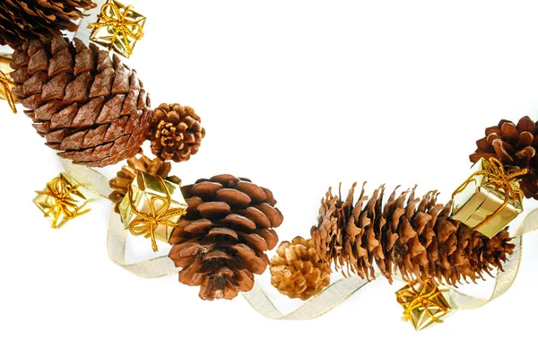 Christmas frame of pine cones and gift boxes on a white background place for text Royalty Free Stock Photos