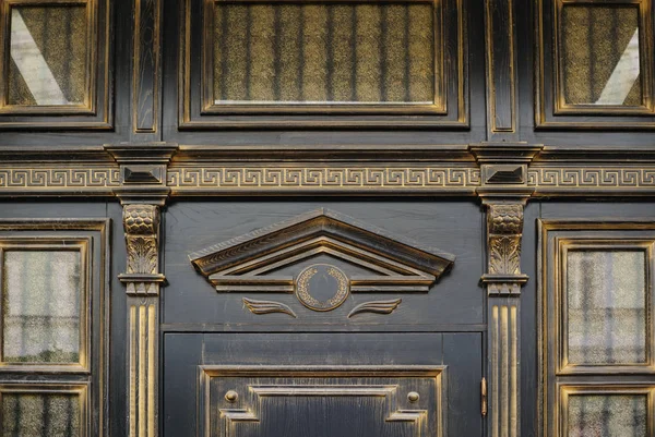 Wood carving with arch above the door in an old building