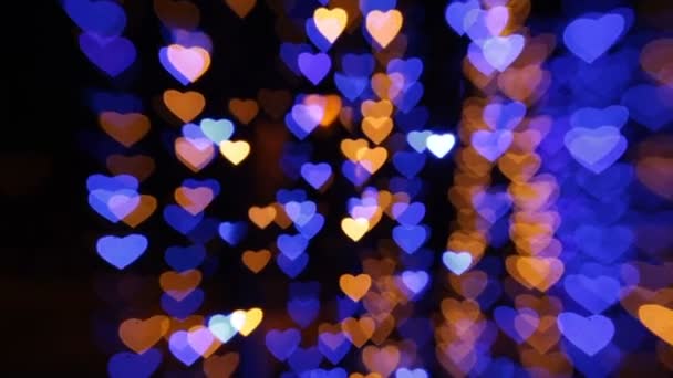 Abstrakt bakgrund med färgade lampor i form av hjärtan — Stockvideo