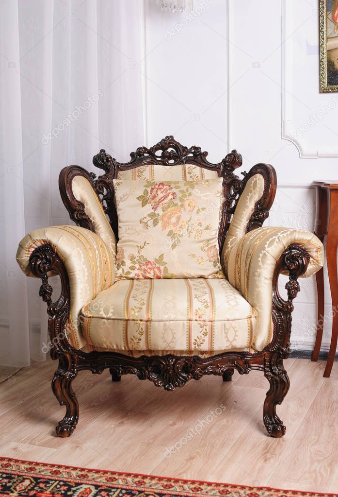 Luxury wooden antique chair in the room