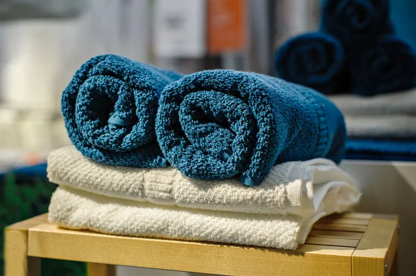 Four clean soft double bath towels set of different colors stacked, lying on wooden chair — Stock Photo, Image