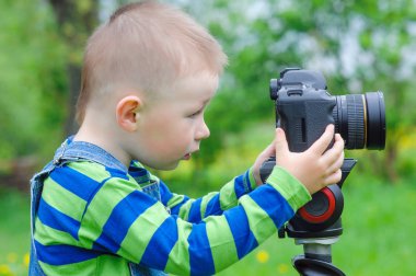 bir fotoğraf makinesi üzerinde küçük çocuk çıkartıyor