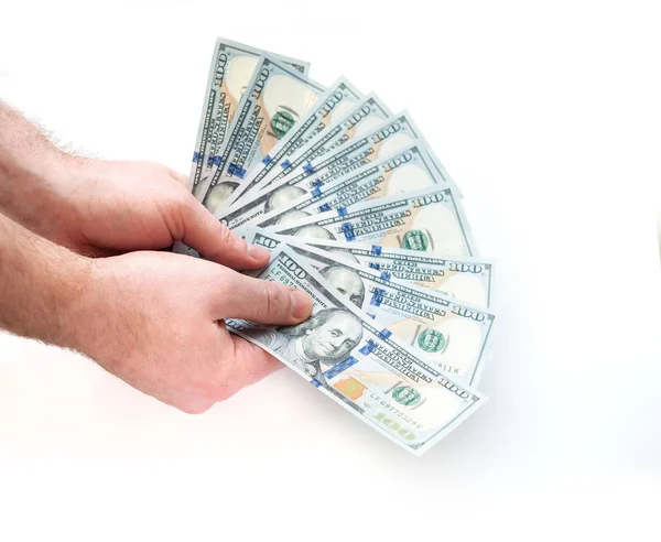 Hombre sosteniendo billetes de cien dólares desplegados sobre un fondo blanco — Foto de Stock