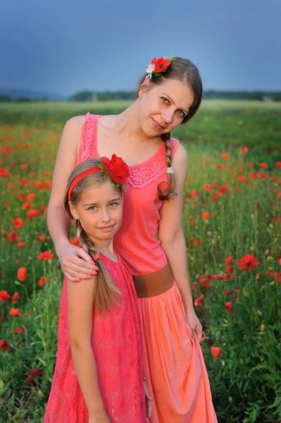 Niña con madre caminando en el campo de amapola — Foto de Stock