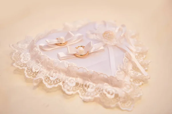 White pillow for rings in the shape of heart — Stock Photo, Image