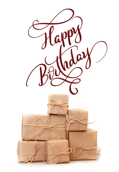 Boxes of kraft paper isolated on white background and text Happy Birthday. Calligraphy lettering — Stock Photo, Image