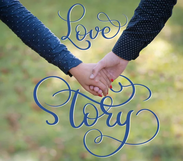 Happy couple holding hands and vintage text Love story. Calligraphy lettering hand draw — Stock Photo, Image