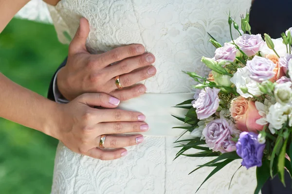 Groom embraces the brides waist on a wedding walk — Stock Photo, Image