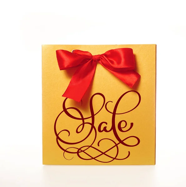Prodej kaligrafie slovo o balíčku s červenou mašlí izolovaných na bílém pozadí. Rukopisné — Stock fotografie