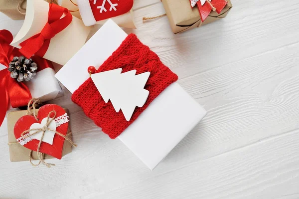 Christmas boxes gift decorated with red bows on a white wooden background. Flat lay, top view photo mockup — Stock Photo, Image