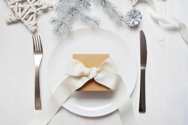 Świąteczne nakrycie stołu z rocznika prezent na biały drewniany stół. Szablon kartki świąteczne z miejsca na tekst, widok z góry — Zdjęcie stockowe