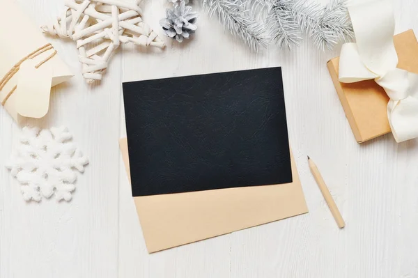 Mockup jul svart gratulationskort brev i kuvert med vita träd, flatlay på en vit trä bakgrund, med plats för din text, platt låg, ovanifrån foto mock upp — Stockfoto
