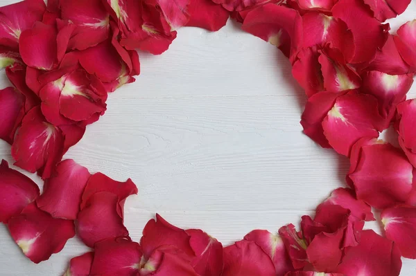Frame gemaakt van rode rozen bloemblaadjes op witte achtergrond. Plat leggen — Stockfoto