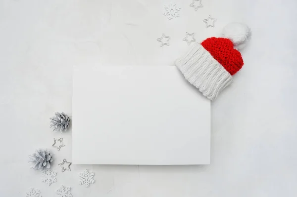 Letter mockup to Santa Claus with Santa red hat on wooden background. Christmas background with cones and snowflakes — Stock Photo, Image