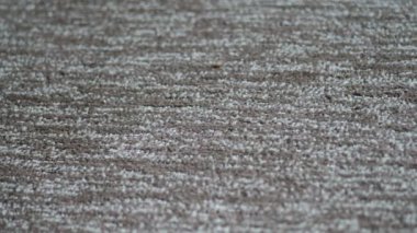 Synthetic carpet on the laminate in the home interior. Close-up texture of textile. 4k video with place for your text. Copyspace