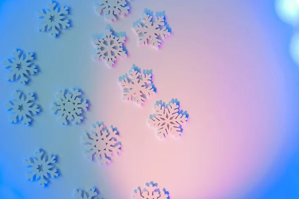Christmas blue neon background with wooden snowflakes with place for your text. Holiday greeting card design with gradient lights — Stock Photo, Image