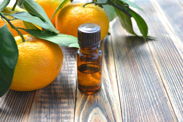 Tangerine cosmetic essential oil in glass bottle. Natural organic cosmetics, aromatherapy and spa concept