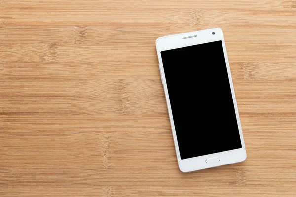 Smart phone bianco con schermo isolato su legno vecchio — Foto Stock