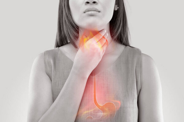 Woman Suffering From Acid Reflux Or Heartburn