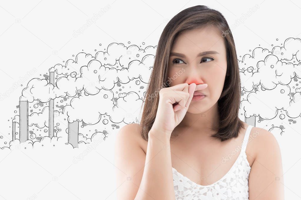 Asian woman in white dress catch her nose because of a bad smell